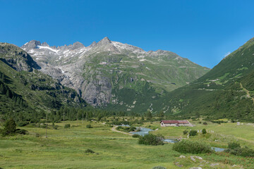 Fototapeta na wymiar Rhone Valley near the hamlet of Gletsch with the Rhone River in front of the Rhone Glacier