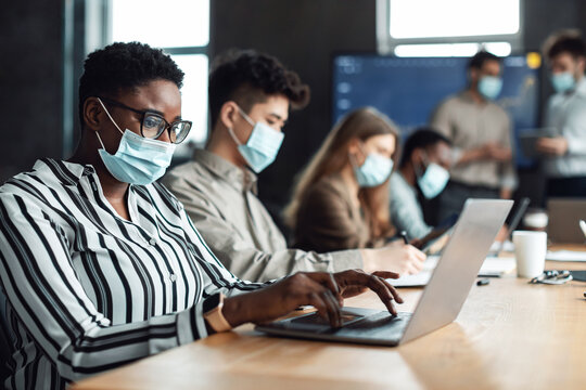 Colleagues working on a project in office, using pc - Powered by Adobe