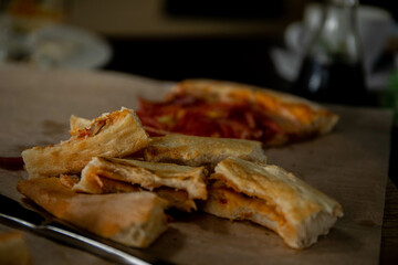 slices of bitten pizza lying on a tray next to a knife and fork pizza crusts