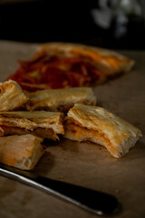 slices of bitten pizza lying on a tray next to a knife and fork pizza crusts