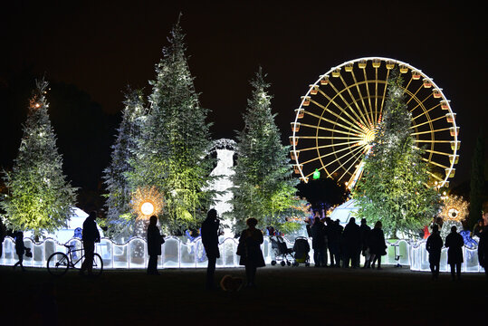 Christmas decorations with snow-covered trees and funfair Ferris wheel. Nice, France