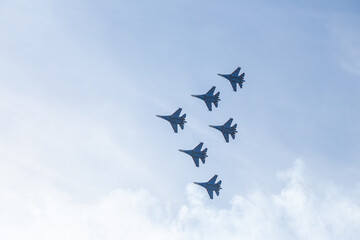 Russian fighter jets fly over a blue sky