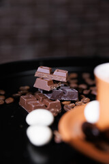Pieces of milk and dark chocolate stacked. Close-up.