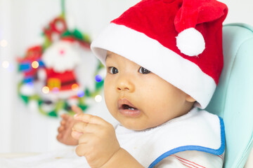 Asian boy wearing a red hat During the time of Christmas Day