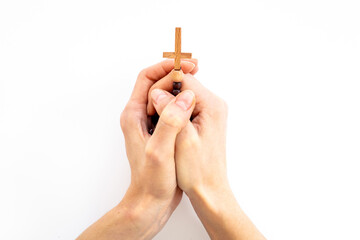 Christian rosary beads cross in hands. Sending prayer concept