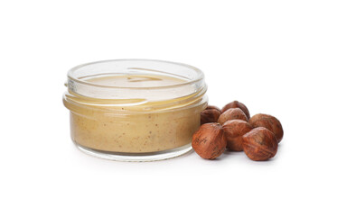 Jar with delicious hazelnut butter and nuts on white background