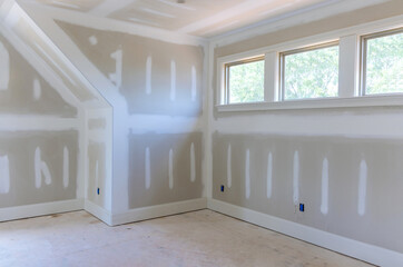 Finishing plastering drywall in ready for paint with new house - obrazy, fototapety, plakaty