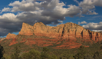 Sedona, Arizona panoramic view of red rock formations with storm clouds and blue sky.