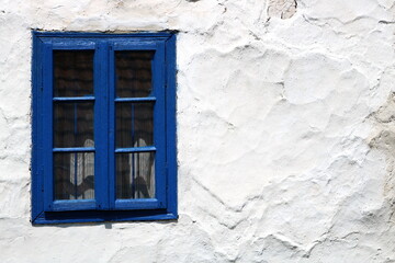 Rustic wood framed window in an old adobe wall