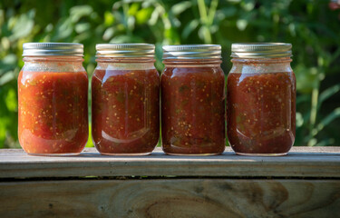 Fototapeta na wymiar Close up look of freshly canned salsa in glass jars.