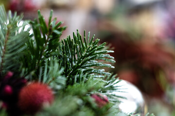 Christmas background - baubles and branch of spruce tree