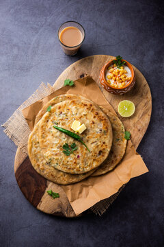 Paneer paratha is a popular North Indian flatbread made with whole wheat flour dough and stuffed with savory, spiced, grated paneer