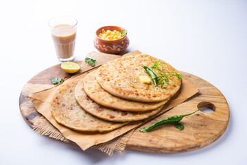 Paneer paratha is a popular North Indian flatbread made with whole wheat flour dough and stuffed with savory, spiced, grated paneer