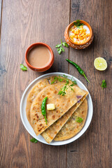 Paneer paratha is a popular North Indian flatbread made with whole wheat flour dough and stuffed with savory, spiced, grated paneer