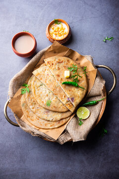 Paneer paratha is a popular North Indian flatbread made with whole wheat flour dough and stuffed with savory, spiced, grated paneer