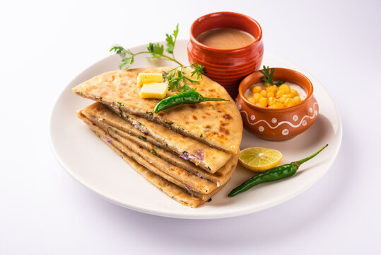 Paneer paratha is a popular North Indian flatbread made with whole wheat flour dough and stuffed with savory, spiced, grated paneer