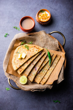 Paneer paratha is a popular North Indian flatbread made with whole wheat flour dough and stuffed with savory, spiced, grated paneer