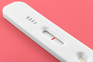 Coronavirus antigen test result abnormal for nasal swab, isolated on a pink background with...