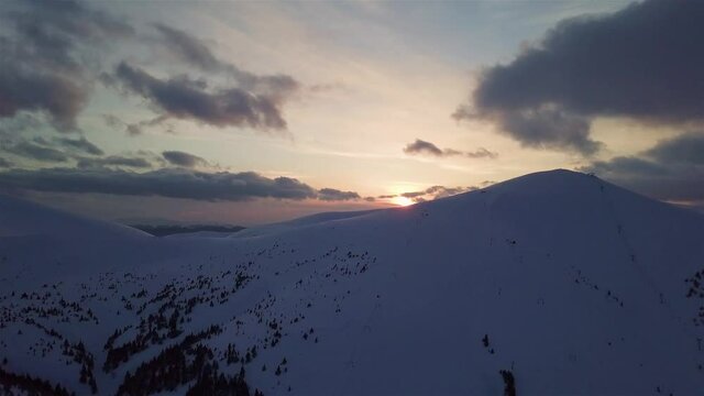 Aerial view of mountain snow-capped peak, at sunset