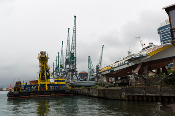 Batumi, Georgia - June 26, 2021: View of the seaport of Batumi. Port cranes. 