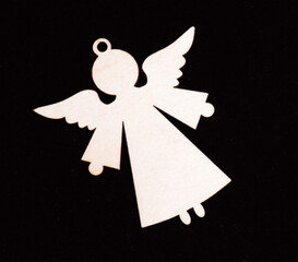 A angel silhouette ornament on a black background. Represents a decorative concept