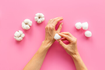 Cotton wool balls in female hands - clean and care for skin