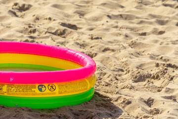 Children's beach pool on a sandy beach.