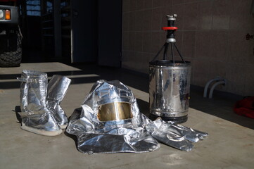Special clothing to protect firefighters from heat exposure and a fire barrel to extinguish...