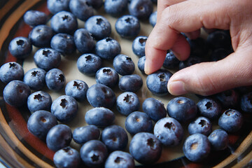 Close up of fresh blue berry with water drops .