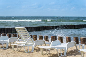 A row of sun loungers on the beach.