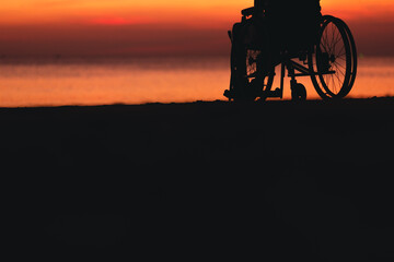 Behind of lower leg person with disability looking sunset on the sea beach at summer, Positive photos give life energy and power concept.