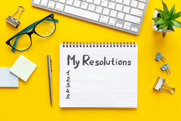 New Year resolution hand writing list - text on notepad, top view