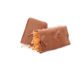 Broken chocolate bar with caramel, nuts and nougat isolated on white, top view