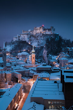 Old town of Salzburg with Hohensalzburg fortress at dusk in winter, Austria
