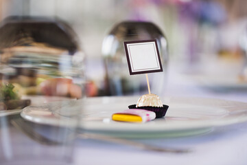 Serving a wedding banquet table in a restaurant with initials, name and date.