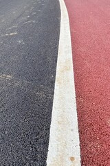Fototapeta premium Vertical pattern of a asphalt road background