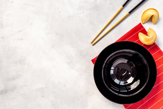Black and gold chopsticks with red mat. Asian tabble place setting