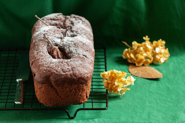 Chocolate pear cake on a green background. Rustic style.