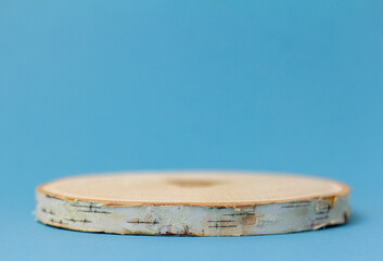 Podium made of natural wood for presentations and exhibitions on a blue background.Space for copying.