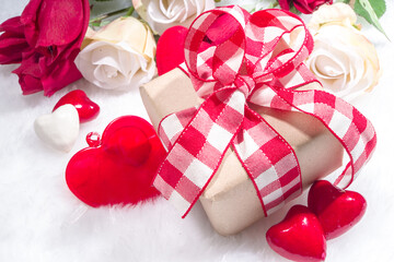 Valentine's Day holiday background. Craft paper gift box with ribbon, rose flowers and hearts decor, copy space