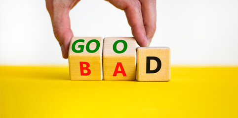 Good or bad symbol. Businessman turns wooden cubes and changes the word bad to good. Beautiful...