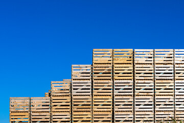 stack of pallets in front of blue sky