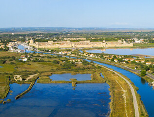 France, Occitanie, Gard, Petite Camargue, the medieval town of Aigues Mortes surrounded by the salt marshes (Salins du Midi) (aerial view)