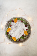 Christmas cake with lights on the grey background.