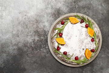 Christmas cake on the dark grey background. Horizontal view.