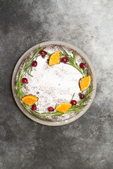 Christmas cake on the dark grey background. Vertical view.