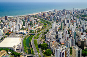 Naklejka na ściany i meble Aerial view of beach with city avenue