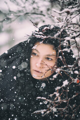 Portrait of a woman near a branch. Winter photo session - 475360315
