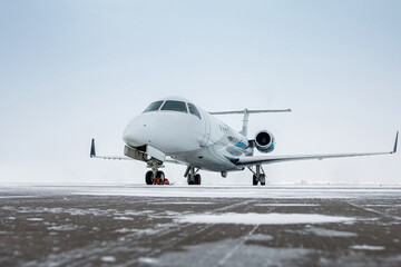 Luxury corporate business jet on the winter airport apron