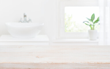 Old wooden tabletop on blur bathroom sink and window background - obrazy, fototapety, plakaty
